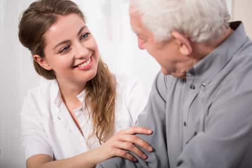 Picture of smiling nurse assisting senior man Picture of smiling nurse assisting senior man